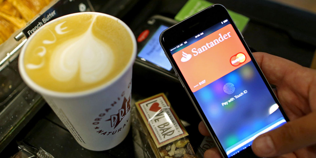 A customer uses an Apple Inc. iPhone to pay via the Apple Pay system, from their Santander account, at the check-out till inside a Pret A Manger Ltd store in this arranged photograph in London, U.K., on Tuesday, July 14, 2015. Apple Inc. is making the U.K. the first market outside the U.S. for its digital-wallet system as the company fights for a place in the electronic-payments industry. Photographer: Chris Ratcliffe/Bloomberg via Getty Images