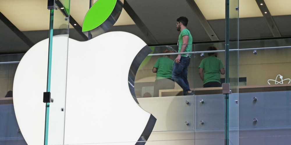 Employees wear green shirts near Apple's familiar logo displayed with a green leaf at the Apple Store timed to coincide with Tuesday's annual celebration of Earth Day in Sydney, Tuesday, April 22, 2014. Apple is offering free recycling of all its used products and vowing to power all of its stores, offices and data centers with renewable energy to reduce the pollution caused by its devices and online services. (AP Photo/Rick Rycroft)