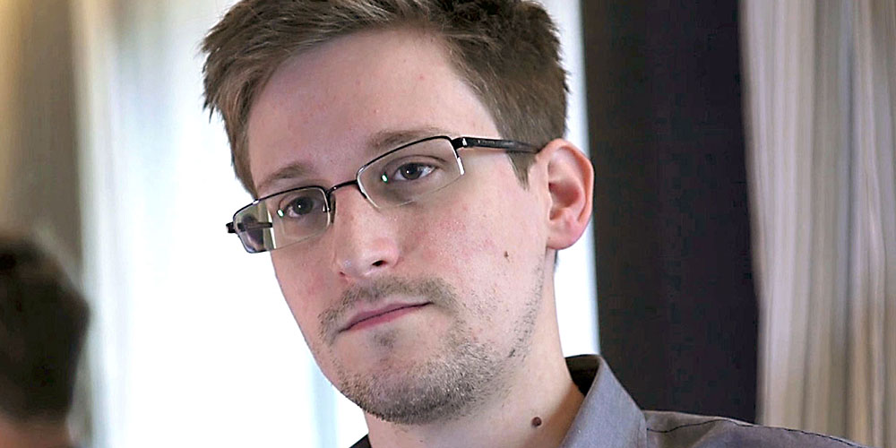 Former U.S. spy agency contractor Edward Snowden is interviewed by The Guardian in his hotel room in Hong Kong...Former U.S. spy agency contractor Edward Snowden is seen in this still image taken from video during an interview by The Guardian in his hotel room in Hong Kong June 6, 2013. Snowden was on July 24, 2013 granted documents that will allow him to leave a Moscow airport where he is holed up, an airport source said on Wednesday. The official, who spoke on condition of anonymity, said Snowden, who is wanted by the United States for leaking details of U.S. government intelligence programmes, was expected to meet his lawyer at Sheremetyevo airport later on Wednesday after lodging a request for temporary asylum in Russia. The immigration authorities declined immediate comment. Picture taken June 6, 2013. MANDATORY CREDIT. REUTERS/Glenn Greenwald/Laura Poitras/Courtesy of The Guardian/Handout via Reuters (CHINA - Tags: POLITICS MEDIA) ATTENTION EDITORS - THIS IMAGE WAS PROVIDED BY A THIRD PARTY. FOR EDITORIAL USE ONLY. NOT FOR SALE FOR MARKETING OR ADVERTISING CAMPAIGNS. NO SALES. NO ARCHIVES. THIS PICTURE IS DISTRIBUTED EXACTLY AS RECEIVED BY REUTERS, AS A SERVICE TO CLIENTS. NO THIRD PARTY SALES. NOT FOR USE BY REUTERS THIRD PARTY DISTRIBUTORS. MANDATORY CREDIT