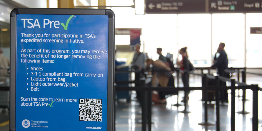 This undated image released by the Transportation Security Administration shows a sign promoting the TSA PreCheck program at at Reagan National Airport in Washington. The Transportation Security Administration's PreCheck program is open to some elite frequent fliers as well as travelers enrolled in one of the Customs & Border Protection's expedited entry programs: Global Entry, Nexus and Sentri. These travelers are considered less of a terrorist risk and therefore don't have to go through as stringent of a screening process. (AP Photo/TSA)