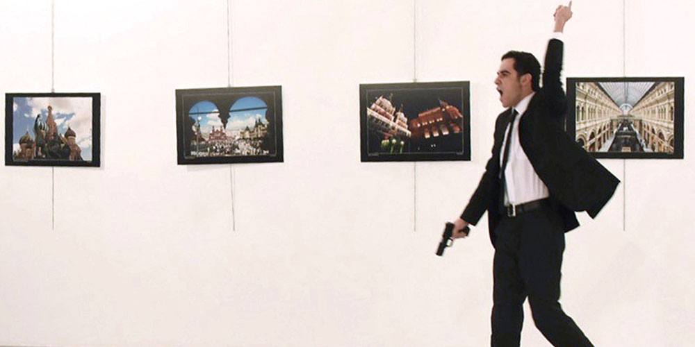 EDITORS NOTE: Graphic content / A picture taken on December 19, 2016 shows Mevlut Mert Altintas, the gunman who killed Russia's Ambassador to Turkey, during an attack during a public event in Ankara. A gunman crying "Aleppo" and "revenge" shot Karlov while he was visiting an art exhibition in Ankara on December 19, witnesses and media reports said. The Turkish state-run Anadolu news agency said the gunman had been "neutralised" in a police operation, without giving further details. / AFP / Sozcu daily / Yavuz Alatan (Photo credit should read YAVUZ ALATAN/AFP/Getty Images)