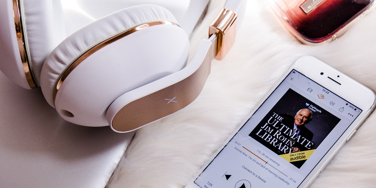 Free audiobooks to be tested by Spotify | Headphones and Audible audiobook shown